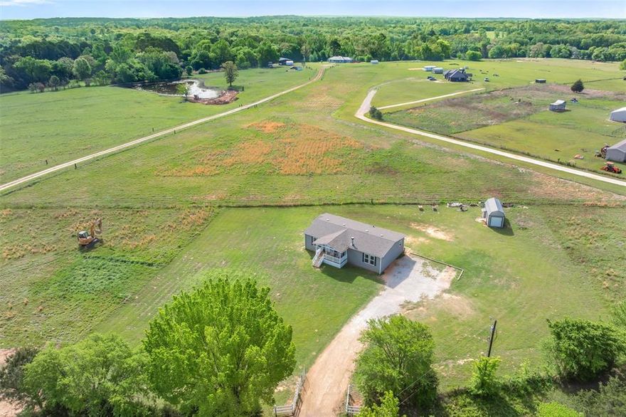 Move-in ready 3BR-2BA modular home on approximately 1.5 acres just minutes from Winnsboro. This well maintained property offers a spacious, open concept layout featuring custom kitchen with island, breakfast bar, & ample cabinetry, along with a cozy WBFP in the main living area. The split bedroom floor plan provides privacy, with generously sized guest rooms +a large primary suite that includes ensuite bath with double vanities, jacuzzi tub, walk-in shower, & walk-in closet. Additional highlights include a large utility room & pantry for added storage & functionality. Exterior features include an expansive yard with plenty of room to enjoy the outdoors & a workshop ideal for hobbies, storage, or equipment. Located in the heart of East Texas, approximately 100 miles from the Dallas-Fort Worth area and within easy access to Tyler & Longview. A great opportunity for those seeking peaceful country living with convenient access to nearby towns. Schedule your showing today.