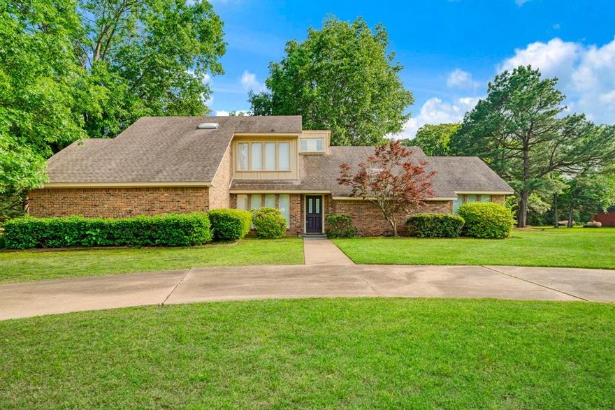 Tucked away in the desirable Twin Lakes subdivision just off FM 195 and moments from the Paris Golf and Country Club, this spacious 4-bedroom, 3-bath home offers the perfect blend of comfort, functionality, and convenience—all set on a beautiful 1-acre lot. Inside, you’ll find a generous living room anchored by a cozy fireplace, a formal dining area ideal for gatherings, and a well-appointed kitchen featuring an island, pantry, and built-in desk for added convenience. The oversized primary suite is a true retreat with a large walk-in closet plus an additional closet near the en suite bath. Three additional guest bedrooms and two full bathrooms provide plenty of space for family, guests, or a home office setup. Storage is abundant throughout the home, ensuring everything has its place. The windows have custom shutters for added privacy and beauty. Step outside to enjoy a large covered patio overlooking the expansive yard, complete with mature trees and established landscaping—perfect for relaxing or entertaining. The circular drive offers ample parking for guests, while the extended primary driveway runs the depth of the property and leads to a small workshop, ideal for hobbies or extra storage. Enjoy peaceful country-style living with the convenience of being just minutes from restaurants, schools, medical facilities, and shopping. Priced for a quick sale so don’t miss your opportunity to make this one yours! See photos for a complete floor plan.