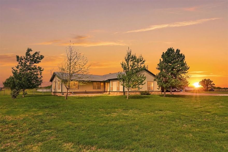 Welcome to this stunning four-bedroom, two-bath ranch-style farmhouse nestled on over three expansive acres in the highly sought-after Grandview ISD. Thoughtfully improved throughout, this exceptional property blends modern design with the charm and tranquility of country living. Step inside to an open-concept floor plan designed for both everyday comfort and effortless entertaining. The gourmet kitchen is a true showstopper, featuring waterfall quartz countertops, a unique walk-through butcher's pantry, and a spacious breakfast bar perfect for gathering. The inviting living room showcases vaulted ceilings and abundant natural light, seamlessly flowing into a large separate dining space ideal for hosting family and friends. The custom primary suite offers a private retreat with a spacious walk-in closet and a beautifully appointed en-suite bath complete with double vanities, a soaking tub, and a separate walk-in shower. Outdoors, this property truly sets itself apart. An incredible metal workshop measuring over 5,000 square feet includes three bay doors, concrete flooring, electricity, and a partially completed apartment with framing already in place, offering endless potential for additional living space, rental income, or a private guest retreat. Additional features include a metal barn, a 10x14 greenhouse, and an above-ground pool with a 25x25 concrete patio, perfect for enjoying warm Texas days. Take in the breathtaking views from the covered front porch or back patio and experience the peace and privacy of wide-open country living. This one-of-a-kind property offers incredible versatility, space, and opportunity and is ready for you to make it your very own!