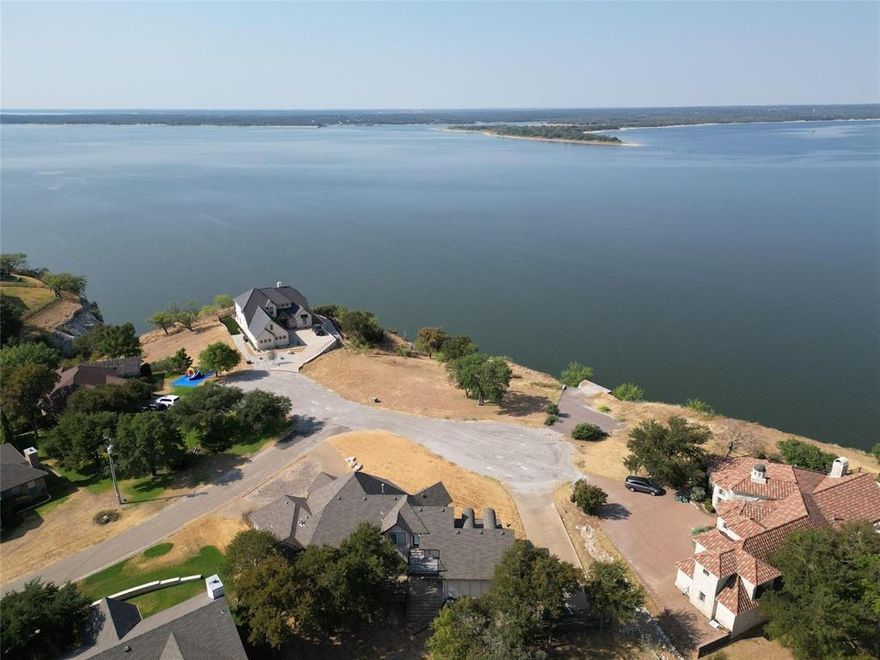 A lot worthy of the home of your dreams, vacation in your own backyard! This lakefront bluff homesite in White Bluff has a sweeping view of Lake Whitney. The property sits in the middle of a quiet cul-de-sac and possesses 100' of lake frontage that is majestically set on top of a bluff 75' above the water. Breathtaking views of the shoreline, highlighted by rugged limestone cliffs contrast with one of Texas' most beautiful lakes. Stunning sunsets! White Bluff is a gated resort & golf community located on over 3,000 acres on Lake Whitney and has all types of wildlife including deer, turkey, and an assortment of birds. Located about 50 miles southwest of Fort Worth. Enjoy 2 dining options, two 18 hole championship golf courses, a fitness center, a marina, 4 swimming pools, 3 tennis courts, fishing lakes, playgrounds, and parks.
Please see photo with approximate location of lot notated.