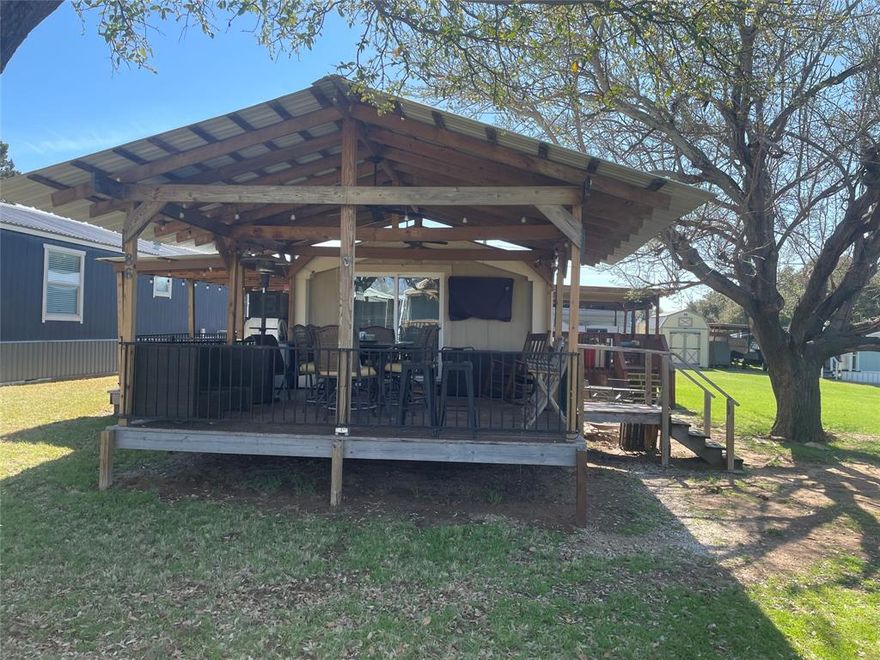 This charming and updated 3 bedroom mobile home offers the perfect blend of comfort and lakeside living, featuring three spacious porches, two with scenic lake views, ideal for relaxing or entertaining. Nestled under a beautiful mature tree, the property includes convenient boat storage and a separate storage shed. Located in a vibrant lakeside community, you'll enjoy golf cart trails, boat rentals, an event pavilion, and access to an active cove for swimming and parking your boat. Whether you're looking for a weekend retreat or a full time escape, this home is your gateway to lake life fun! Some furniture negotiable. Leasehold Land. Agent 2 is property owner.