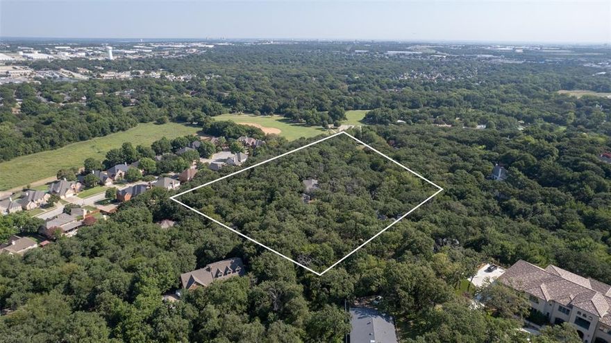 A rare opportunity in the Colleyville–Grapevine area: this secluded 4.5+ acre, two-tract property offers unmatched skyline views and exceptional privacy. Tucked away at the end of a private road, the setting is wooded, quiet, and expansive—an ideal canvas for your dream estate. The true value here is in the land: an irreplaceable site with panoramic vistas stretching toward Grapevine, Southlake, and beyond. Large neighboring estate homes are already established or underway, further underscoring the long-term investment potential of this property. Bring your own builder to create a one-of-a-kind residence that takes full advantage of the remarkable topography and scenery.