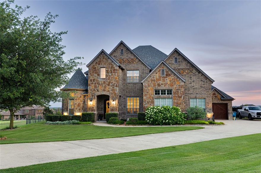 Experience refined living at 7757 Bella Milano Drive in the prestigious Bella Flora community of Fort Worth. Tucked away on just under 2 acres in a quiet cul-de-sac, this 4-bedroom, 3.5 bath home blends privacy, space, and elevated design in one of the area’s most sought-after guard-gated neighborhoods.
The outdoor setting is built to impress and unwind. Enjoy a resort-style pool and spa, expansive covered patio with fireplace, fully equipped outdoor kitchen, dedicated lounge area, fire pit, and your own private putting green, all designed for year-round entertaining and relaxation.
Inside, the home offers a functional and spacious layout with a 3-car garage, ideal for modern living. Located in highly acclaimed Aledo ISD, this property delivers both lifestyle and long-term value.