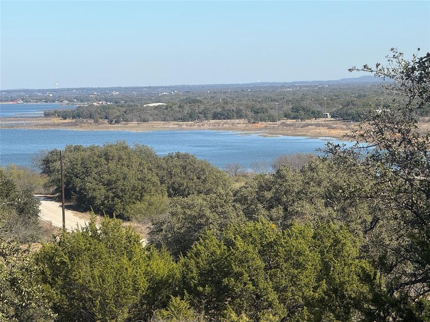 Take in a stunning, elevated view of Lake Brownwood right from your future backyard. This prime lot in The Hideout Resort sits high on a hill along Anchors Away, giving you a sweeping lake panorama that feels downright cinematic. The elevation isn’t just pretty—it’s the kind of view that makes morning coffee and evening sunsets feel like a daily vacation.

Ownership includes full Hideout Resort membership benefits: four rounds of golf each month, discounted cart fees, and access to all the amenities. Enjoy the resort-style pool, tennis and pickleball courts, fitness center, clubhouse, and a long list of extras designed for relaxation, play, and pure Texas lake living. The perfect location for a lakeside retreat or a forever home!
