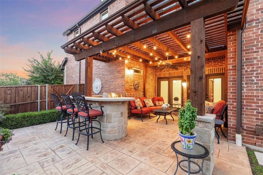 Welcome to Savoy Landing—a small, gated, and highly sought-after community in Richardson known for its charm, privacy, and convenience. This beautifully maintained 4-bedroom, 3-bath home offers a blend of timeless elegance and modern comfort, wrapped in a light-filled, open-concept layout designed for everyday living and effortless entertaining. Step inside to warm wood floors, soaring ceilings, and natural light pouring through expansive windows. The heart of the home is the stunning kitchen, featuring an oversized granite island, stainless steel appliances, a gas cooktop, rich cabinetry, and designer lighting. It seamlessly opens to the two-story living room, where wood floors, a cozy fireplace, and floor-to-ceiling windows create an inviting space for gathering, relaxing, or simply enjoying the view. A private secondary bedroom with a full bath is located on the main level, perfect for guests or multigenerational living. A versatile front flex room offers the ideal space for a home office, study, or sitting room. Upstairs, the primary suite is a peaceful retreat—bright, spacious, and private—with vaulted ceilings, plantation shutters, and ample room for a sitting area or lounge. The ensuite bath features dual vanities, a large walk-in shower, and a generous closet. Two additional bedrooms, another full bath, and a large gameroom or second living area complete the upper floor. Step outside to your own backyard escape. The covered patio with cedar pergola, built-in stainless grill, and stone bar seating is perfect for weekend cookouts or quiet evenings at home. Thoughtful landscaping, lush greenery, and a tranquil water feature add serenity and privacy to this inviting outdoor space. Located just minutes from CityLine, major highways, shopping, dining, and entertainment, Savoy Landing offers both lifestyle and location. Experience the community feel and everyday comfort that make this gated neighborhood one of Richardson’s best-kept treasures.