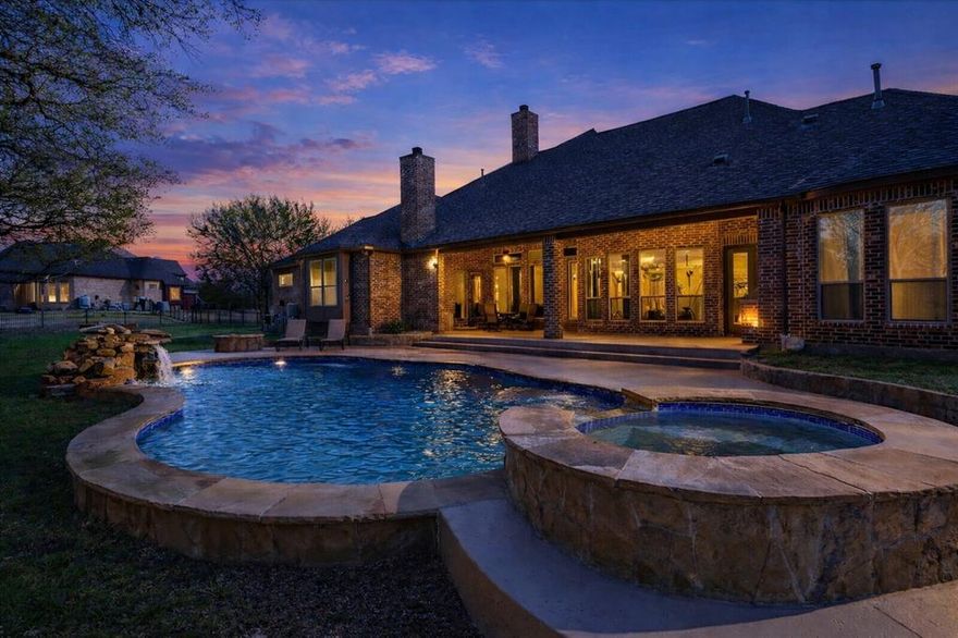 Tucked away on a quiet cul-de-sac street in highly sought-after Lovejoy ISD, this exceptional single-story estate offers a rare opportunity to own a private, acreage retreat without sacrificing proximity to everything you need.

Set on 2 beautifully treed acres with a serene wooded backdrop, the property immediately evokes a sense of calm, space, and seclusion - something increasingly difficult to find. Designed for both everyday comfort and elevated entertaining, the home unfolds with intention, offering expansive living spaces, soaring ceilings, and rich architectural detail throughout.

At the heart of the home, the main living area is anchored by a dramatic stone fireplace and framed by walls of windows that draw the outdoors in. The open-concept design flows effortlessly into the kitchen and dining spaces, creating an environment that feels both connected and refined.

Step outside and the experience continues. The backyard is a true extension of the home - complete with a sparkling pool, spa, and a covered patio featuring an outdoor fireplace and built-in grill. Whether hosting under the stars or enjoying a quiet evening at home, this space was designed to be lived in year-round.

With four spacious bedrooms (with en-suites) and thoughtfully designed private spaces, the home offers flexibility for multi-generational living, guests, or dedicated work-from-home environments - all without compromise.

For the discerning buyer, the five-car garage is a standout feature, offering not only ample storage but the ability to accommodate a boat or recreational vehicle - perfect for weekends at nearby Lake Lavon.

Opportunities like this are few and far between: a single-story home of this scale, on acreage, with amenities, in one of the area’s most coveted school districts.

This is more than a home - it’s a lifestyle. Schedule your private showing today!