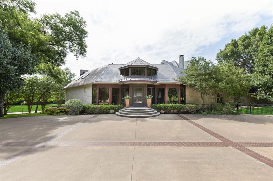 Unique, gated 1.34 acre property adjacent to White Rock Lake, featuring multi-story home with beautifully landscaped grounds, large pool and spa. Home includes 7 bedrooms, each with ensuite bathrooms, including an apartment with full bath and kitchenette. Large master includes separate area ideal for office use. Foyer opens into a separate formal dining room and piano room leading into formal living area with a vaulted wood ceiling, skylights and bar. Spacious den below includes another full bath, a 650-bottle capacity wine cellar and bar. Gorgeous oak floors throughout main level. The exterior is clad in Indiana Limestone with slate roofing and includes decks on multiple levels overlooking a greenbelt, with views of White Rock Lake. Kitchen includes a 6 burner, commercial grade stove with double-oversized ovens and full size, side-by-side Sub Zero refrigerator and freezer. This beautiful one-of-a-kind property is perfect for family living and entertaining.