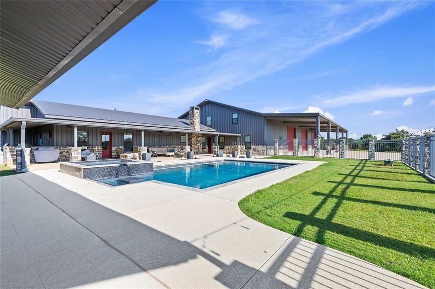 Welcome to your luxury country estate in Boyd, Texas — where modern comfort meets wide-open space and endless opportunity. Nestled on 11.9 fully fenced, Ag Exempt acres, this property offers an incredible lifestyle with room to grow, entertain, and unwind in total privacy. The custom-built home features over 4,000 square feet of beautifully designed living space, perfectly blending rustic charm with contemporary finishes and thoughtful details throughout. The heart of the property is the massive 60x80 sqft shop, fully equipped with AC and heat, living quarters, floor drains, and ample space for any project, hobby, or business endeavor. Whether you're running equipment, housing RVs, storing vehicles, or converting it into a dream workspace, this versatile shop is ready for it all. Outdoors, enjoy a resort-style pool with both a heater and chiller for year-round use, plus a poolside bar complete with custom furniture — ideal for hosting summer parties, weekend get-togethers, or relaxing evenings under the stars. Nearby, a pavilion with RV hookups offers the perfect venue for weddings, celebrations, family reunions, or the ultimate game-day experience. Additional features include a custom storm shelter that provides both peace of mind and extra storage, a stocked pond offering gorgeous views and a tranquil setting, and a high-quality water filtration system for added comfort and convenience. Furniture is negotiable, making your move-in process seamless, and farm equipment is available for sale, presenting a turn-key opportunity for anyone ready to embrace authentic country living with modern amenities. This is more than just a home—it’s a lifestyle. Whether you're searching for a private family retreat, a space to entertain, or a versatile homestead with income potential, this exceptional property delivers on every level. Come experience modern country living at its finest. TXT keyword Lonestar1 to 88000 for more photos and video!!