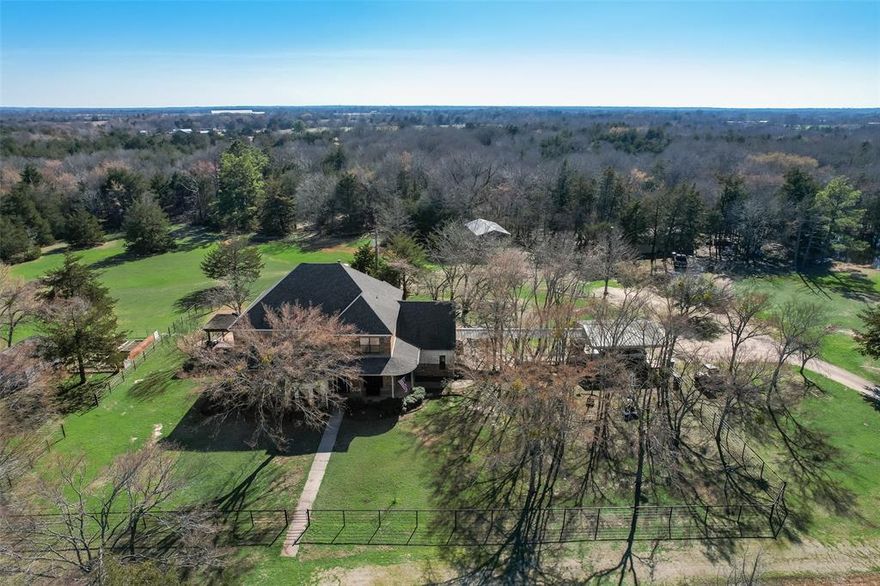 Welcome to peaceful country living where life moves a little slower and the views stretch wide. Set on 10 ag exempt acres with a stocked pond, this well-built custom home offers privacy, open skies, and quiet surroundings just minutes from Greenville, Lake Tawakoni, and I30. The open floor plan is filled with natural light and features soaring ceilings, a stone fireplace, and custom builtins that give the home warmth and personality. The kitchen offers stainless appliances, generous counter space, and a large island that flows into the dining area, easy for everyday living, casual meals, and time spent together. The primary suite overlooks a tree lined backyard and includes a spa style bath with soaking tub, separate shower, and dual vanities.
Upstairs are two additional bedrooms, a flexible bonus space, and a private media room with access to the outdoor balcony, ideal for guest  or relaxed movie nights. Step outside to a multi-level deck with hot tub, fire pit area, and a screened in patio, perfect for slow mornings, quiet evenings, and enjoying the stillness of the land. The partially treed acreage allows for horses, gardening, or simply room to roam. A gated drive offers privacy and a welcoming sense of arrival. A 30x40 RV or boat storage building includes 50 amp shore power. An additional 18 acres is available to purchase adjoining to this property. Immaculately cared for, thoughtfully designed, and full of peaceful moments, this is a home that invites you to slow down and truly enjoy where you live. Partially fenced. Stocked pond on property. Located within 30 minutes of 3 different lakes in the area. New survey on file. Two car covered parking complete with concrete slab. Would be easy to enclose for a full 2 car garage.