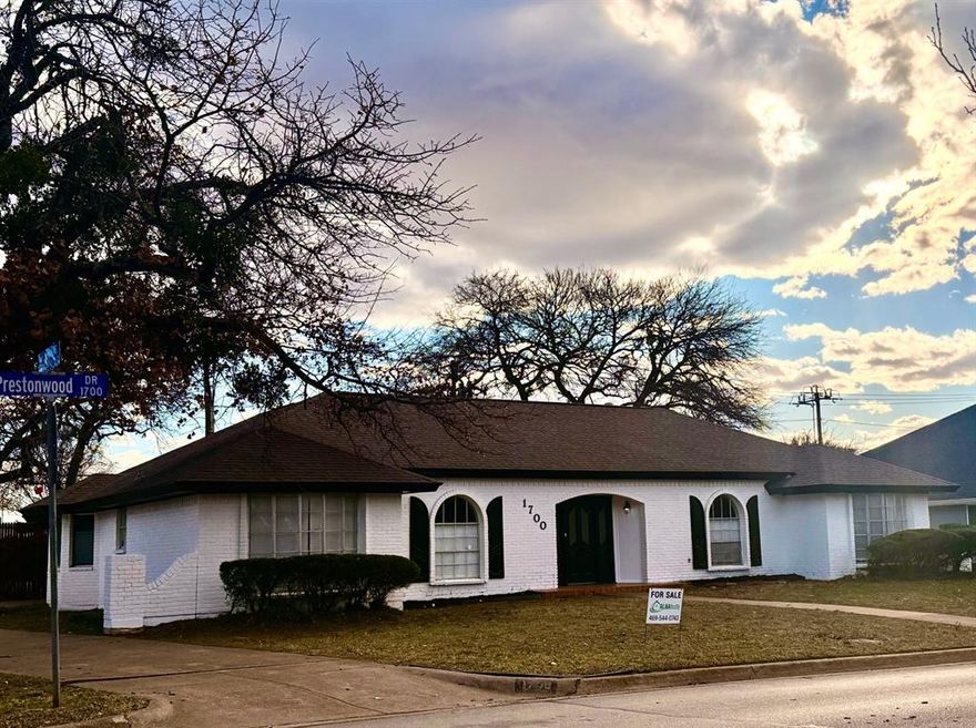 Prime location with exceptional convenience! 
Welcome to 1700 Prestonwood, a corner-lot home offering the perfect blend of accessibility and neighborhood charm. Enjoy quick and easy access to Interstate 30 while still being nestled in a quiet, established community. Just minutes from Arlington’s sought-after Entertainment District—including AT&T Stadium, Globe Life Field, dining, and shopping—this home places you close to it all without sacrificing peace and privacy. The functional layout features bright, open living areas and a kitchen that flows seamlessly into the main living space, ideal for entertaining or everyday living. Generously sized bedrooms provide comfort and flexibility, while the private patio and backyard offer an inviting space to relax or host gatherings. Located behind a school for added privacy, this well-positioned property is a must-see—schedule your showing today!