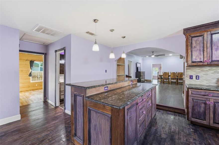 Discover this unique and beautifully designed home, ideal for a large family that loves to stay together. The property features a private mother-in-law suite located at the back of the home—separate from the main living area—with an open-concept floor plan and its own full bathroom, offering the comfort and privacy of a loft-style retreat. The main home showcases custom woodwork throughout, adding warmth and character to every room. Some rooms and bathrooms have a ranch style custom touches. With multiple bedrooms, there’s plenty of flexibility for home office, guest rooms, or creative spaces. Enjoy the convenience of two master bedrooms, one featuring a cozy nursery nook, and even a dedicated workout area for your fitness needs. The large dining area is perfect for hosting family gatherings and celebrations. Additional highlights include a side entrance with ample parking for multiple vehicles and countless thoughtful details that make this home truly special. Don’t miss out on this incredible opportunity to own a one-of-a-kind property designed for comfort, versatility, and family living!