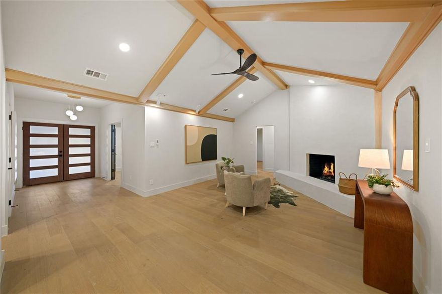 Do not miss this mid-century modern 3,728 SF GEM - fully renovated from top to bottom! Welcome to 7736 Woodstone Lane, a magazine-worthy 5-bedroom + office, 3.5-bath home situated on a 0.32-acre lot on a quiet street in Far North Dallas. Thoughtfully redesigned by an interior designer with top-tier finishes and modern upgrades, this home blends style, function, and comfort at every turn. Step inside to an open-concept layout featuring a cozy fireplace with Venetian plaster surround, a chic wet bar, designer lighting, and seamless flow between the living, dining, and kitchen areas. The gourmet kitchen is a true showpiece, offering expensive custom-built white oak inset-style cabinetry, quartz countertops with dolomite backsplash, a 10-ft eat-in island, and all-new premium SS appliances. The spacious primary suite includes a large walk-in closet and a stunning ensuite bathroom featuring Bedrosians & Terrazzo tile, a standalone soaking tub, an oversized double-rain shower, and a dual vanity. Two additional bedrooms share a beautifully upgraded Jack-and-Jill bath with a walk-in shower, while two more bedrooms share a sleek hall bathroom with tub - ideal for guests and conveniently located near the kitchen area. A spacious office is positioned near the front entry. Beautiful engineered white oak hardwood flooring flows throughout the home, complemented by designer tile in baths. Step outside to a private and spacious backyard featuring lush landscape, new sod, a pergola and an outdoor kitchen - perfect for relaxing or entertaining. The oversized driveway offers parking for up to six cars, plus a two-car garage. Conveniently located near premier shopping, dining, and entertainment with quick access to PGBT and DNT, this home offers exceptional convenience to all your favorite Dallas destinations. A full list of features & upgrades has been uploaded to MLS. This home offers not just a place to live, but a lifestyle. Schedule your tour today!