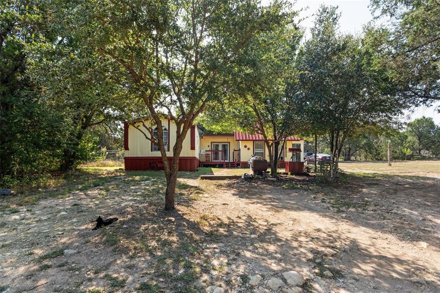 Tucked away among mature trees, 2719 River View Trail offers 3.107 acres across two parcels, providing complete seclusion and privacy. The property features a 1,320 sq ft residence, which includes a single-wide mobile home attached to a 300 sq ft structure, plus two additional cabins for guests, storage, or hobby use.
Being sold as-is, where-is, this property offers endless possibilities renovate, invest, or build new. With space for livestock, gardening, or outdoor recreation, and still just minutes from Lake Granbury, shopping, and schools, this unique property delivers both privacy and convenience.
