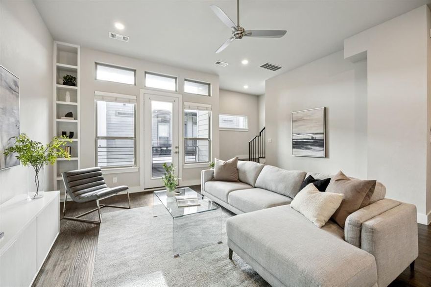 Light-filled, clean, and modern, this beautifully maintained East Village condo features a smart layout with comfortable living areas and quality finishes. Gorgeous hand-scraped hardwood floors set the tone as you enter the open and airy space, where tall ceilings and expansive windows create a bright and welcoming atmosphere. The living area flows easily into the kitchen, making it ideal for everyday use as well as entertaining. The kitchen includes granite countertops, ample cabinet storage, a large island, a large pantry, and stainless steel appliances. A covered balcony provides a great spot for morning coffee or unwinding in the evenings. The first-floor home office offers privacy and a quiet place to work. The primary suite includes an oversized bedroom, a walk-in closet, and a sleek bathroom with dual sinks and a spacious stand-up shower with a bench. The top floor also features a guest suite with its own ensuite bath. Additional highlights include an attached two-car garage and gated access for added privacy and peace of mind. With low-maintenance living and a location that’s hard to beat, you’ll enjoy being just moments from East Dallas favorites like Knox Henderson, Lower Greenville, Deep Ellum, Cityplace, Uptown, and numerous restaurants, shops, and nightlife options. A must-see home at an incredible price in one of the city's most convenient neighborhoods.