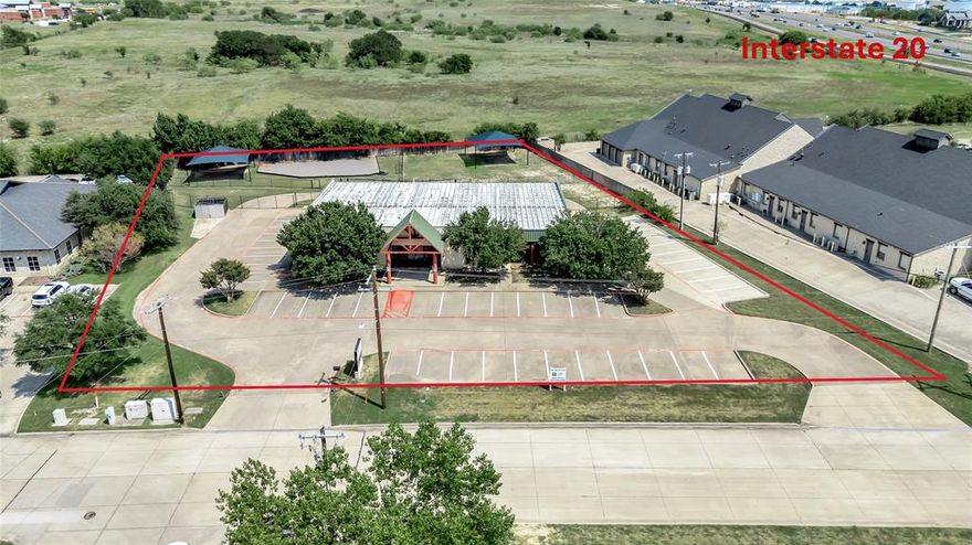 Prime commercial property in the heart of Willow Park! This 7,125 SF building sits on nearly 1.5 acres, is in excellent condition. Perfectly designed for medical or professional office use, with plumbing and bathrooms in every room, a full kitchen and a flexible layout that includes 8 exterior doors for easy subdivision. A rare owner-user opportunity in one of Parker County’s fastest growing communities. Located directly off I-20 frontage, conveniently positioned between Weatherford and Aledo with quick access to the greater Fort Worth area. The site benefits from traffic counts of over 90,000 cars per day. Interior features inlcude a front welcome office with a receptionist sliding glass window and quality built-in cabinets, a dedicated mechanical room and two large storge closets.  Exterior features include 56 parking spaces, gated and fenced back area, a drive-through previously used for a pharmacy. Favorable zoning allows for a variety of uses, and the property’s design and location make it ideal for healthcare providers, professional offices, or multi-tenant occupancy. With strong demographics, rapid area growth, and excellent accessibility, this property offers the perfect balance of functionality and long-term investment potential.