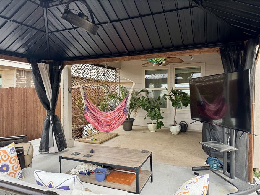 Beautifully upgraded and maintained home offering a functional open layout, numerous updates, and unmatched outdoor living space. Durable tile flooring runs through the main areas, and natural light keeps the home feeling bright and inviting. The kitchen features granite countertops, stainless steel appliances, white cabinetry, a large island with bar seating, and updated fixtures. It opens directly to the dining and living areas, making it easy to host or keep everyone connected day to day. The living room includes a custom accent wall that adds warmth and character. The primary suite is privately positioned and offers a spacious bedroom, double vanity, large standing shower and walk-in closet. Secondary bedrooms are well-sized and provide flexibility. Bathrooms are clean and modern, and the dedicated laundry room includes added upper shelving for extra storage. Outside, you’ll find an extended covered patio with a substantial pergola, lighting, mounted TV space, and room for multiple seating areas - a true extension of the home with plenty of yard space left for gardening, play or pets. The home carries an FHA loan at 4.75% that is assumable for qualified buyers. Come see it today!