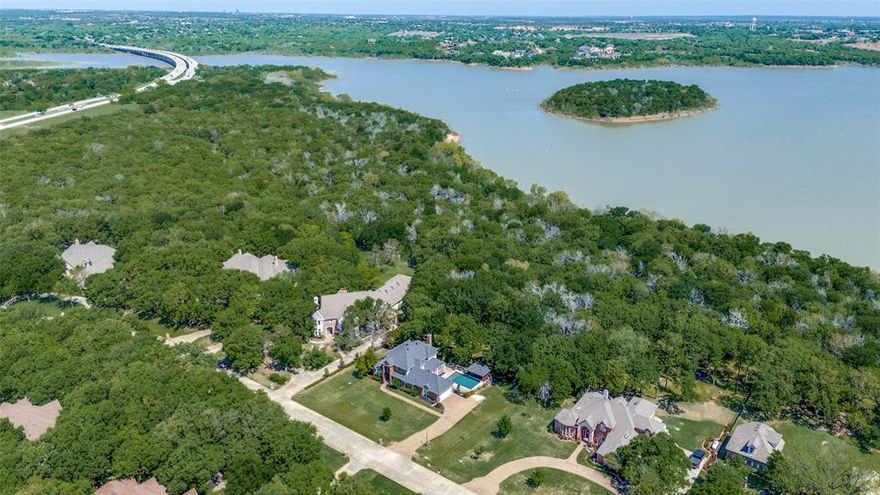 Welcome to 4007 Brooks Court, a rare gem tucked away on a quiet tree-lined cul-de-sac in Argyle. This beautiful 1.03-acre property backs directly to US Army Corps land bordering Lake Lewisville, offering unmatched privacy and direct access to hiking trails, boat launches, and lake activities.

Inside, you will find an inviting open-concept layout with custom faux finishes, slate flooring, and serene views of the wooded backyard. The remodeled kitchen is a chef’s dream, featuring quartz countertops, stainless steel appliances including refrigerator, oven, microwave, and dishwasher, custom cabinetry, and large windows that bring in natural light.

The primary suite includes a spacious bedroom and an updated bathroom with a separate shower and soaking tub. Other highlights include a dedicated study, formal living and dining rooms, and a game room perfect for entertaining or relaxing.

Step outside to your private backyard retreat complete with an outdoor kitchen, sparkling pool, and plenty of space to relax or entertain. The oversized two-car garage provides generous storage.

Located just minutes from shopping, dining, and top-rated schools, this home offers the perfect blend of privacy and convenience. A must-see for anyone looking to enjoy the best of Argyle living.

Recent upgrades include windows, kitchen, pool and patio