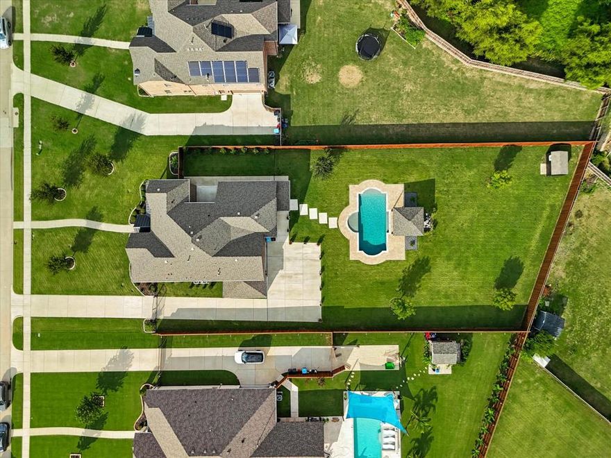 Stunning 5-bedroom, 5 full bath home w a dedicated office, game & private media room situated on a .65 acre lot in the Stoney Creek community of Sunnyvale ISD, just minutes from Lake Ray Hubbard! Luxury upgrades & pristine condition throughout. The automatic gate leading to your own private opulent oasis featuring a newly installed sophisticated fence completes this estate. This residence looks & feels like new, offering a rare combination of space, privacy, & functionality.

Nailed-down hand-scraped hardwood flooring throughout the main living areas downstairs, new carpet & abundant natural light. The kitchen is beautifully appointed w premium cabinetry, under-cabinet lighting & an open layout ideal for both everyday living & entertaining. A glass iron door leads to the side patio, providing seamless indoor outdoor flow w gas grill connection, & access to a separate yard for your four-legged friends.

The oversized primary suite features a custom walk-in closet, spa-like en-suite w direct access to the fully equipped laundry room you have been dreaming of! Every bedroom includes access to a private bathroom along w custom closets, making this home ideal for everyone, including multi-generational living. A flexible downstairs room can serve as a home office or additional living space. Game & Media w theatre seating complete the 2nd level!

Entertainer’s dream backyard! Beautiful pool w a premium pebble surface, oversized pool deck, & a cabana to enjoy outdoor living at its best. Additional outdoor spaces include a covered rear patio & an oversized covered front porch. The impeccable lawn enhances the home’s exceptional curb appeal.

Parking & storage are abundant, w a 3-car garage w epoxy flooring offering private rear access, an extra-long & wide gated side driveway, & additional parking space. Permanent holiday lights included! Located in a quiet, well-maintained neighborhood, this home is truly move-in ready & offers luxury living w room to grow.