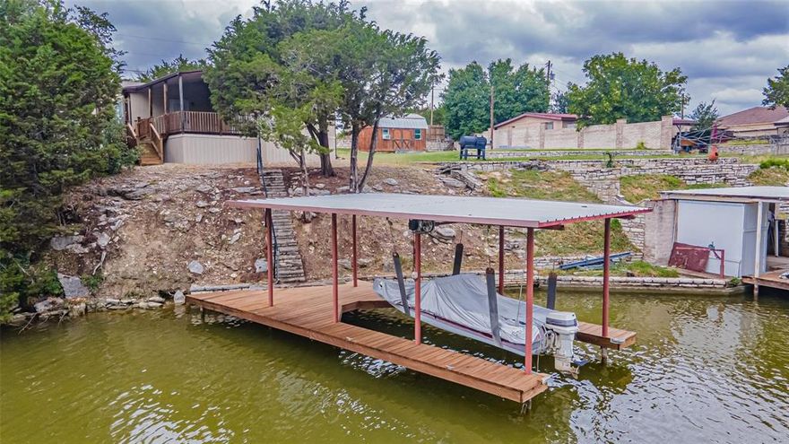 New listing on Great Lake Frontage! Fantastic view of large cove, covered boat dock with lift, retaining wall, very private location. Great for weekend entertaining or retirement place. 3 Bedroom, 2 bath, 2 spacious living areas, 2 car carport. Large porch with view of the lake.
