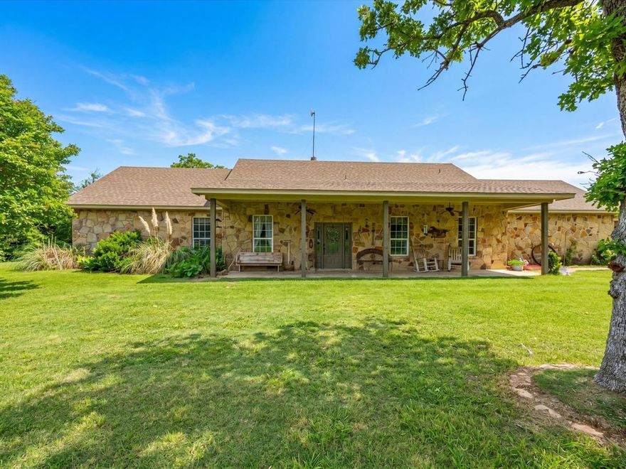 Tucked away in peaceful seclusion, this beautiful 11.36-acre property offers space, privacy, and the freedom of country living while still being conveniently located just minutes from both Bridgeport and Paradise. With over 2,000 square feet of living space, this single-owner home has been thoughtfully cared for and provides the perfect setting for those looking to spread out and enjoy the land. Inside, the home features four bedrooms and three full bathrooms with a comfortable layout designed for both everyday living and hosting family and friends. The living area is anchored by a warm wood-burning fireplace that creates an inviting gathering space. The spacious primary suite offers a relaxing retreat with dual sinks, a jacuzzi tub, a walk-in shower, and separate his and hers closets. The land itself is truly the highlight. Fully fenced and cross-fenced with a new fence in place, the property carries an agricultural exemption and offers excellent opportunities for livestock, recreation, or simply enjoying the natural surroundings. Wildlife is abundant, including regular deer sightings, adding to the quiet country atmosphere. A 50x30 insulated shop with electricity provides incredible versatility. The shop is already plumbed and set up for a future bathroom, making it ideal for projects, equipment storage, or additional workspace. The property also includes multiple stall spaces with electricity available, perfect for agricultural or hobby use. Two water wells service the property, one over 130 feet and another over 300 feet deep, along with two septic systems already in place. A water softener is also installed for added convenience. There is an existing single-wide on the property that is owned by a family member and not part of the sale. Located on a maintained easement road with little to no through traffic, this property offers exceptional privacy while still being only about five miles from both Bridgeport and Paradise and within Paradise ISD.