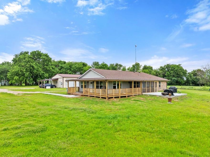 Spacious and serene country living awaits at 195 County Road 4612, offering a rare opportunity to own a private 10-acre retreat with multiple residences and exceptional amenities. This charming and well-maintained 3-bedroom, 2-bath brick home features an open-concept living and kitchen area, tile flooring throughout, and thoughtful updates including roofing, gutters, and an expanded addition to the main house. Designed for both comfort and functionality, the property also includes a newly built secondary home, a cozy tiny home, and a storm shelter with convenient access from inside the main residence. The land itself is flat, usable, and fully fenced—ideal for animals, recreation, or creating your own homestead. Enjoy peaceful views of the private pond, along with fruit trees, garden space, and tranquil outdoor living areas perfect for relaxing or entertaining. A large 3-bay shop provides ample space for equipment, hobbies, or storage, and a generator adds an extra layer of preparedness and convenience. Tucked away for privacy and tranquility, yet located just a short drive from town, this unique property offers the best of both worlds. Whether you're seeking multi-generational living, income potential, or simply room to roam, this one-of-a-kind estate is ready to meet your needs. No HOA and easy access to DFW make this an exceptional opportunity you don't want to miss.