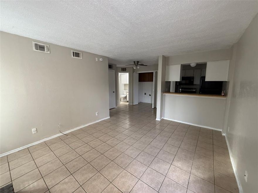 Cozy 1BR 1BA condo with brick fireplace, patio-terrace, washer-dryer area, kitchen appliances included, assigned parking, easy access to highways (75 & 635) and shopping