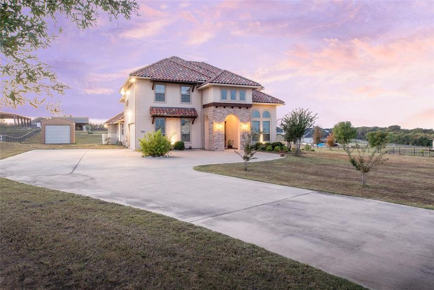 Stunning Custom Mediterranean Estate on 2 Acres with Lake Views. Experience luxury and craftsmanship in this custom-designed home by award-winning builder Homes by J. Anthony, completed in 2018. Nestled on 2 acres with scenic lake views and just a short walk to Lavon Lake, this residence seamlessly combines elegance, functionality, and outdoor living. Featuring 3 bedrooms, 3 full bathrooms, and 2 half bathrooms, the home offers abundant space with a media room, home office, additional study area, formal dining, living room, and a versatile game area. High ceilings, wood plantation shutters, generous counter space, and ample cabinetry enhance the interior’s comfort and style. Step outside to a screened patio with built-in grill, a balcony, and enjoy the beautifully maintained 6-foot-deep pond with aerator and liner (2024). The property also includes a 15 ft x 30 ft barn, solar-powered automatic entry gate, and iron fencing (2021) — perfect for hobbies, storage, or entertaining. The Mediterranean-style exteriors with stucco walls and tile roofs provide exceptional durability, energy efficiency, and lower insurance costs, while the expansive lot offers complete privacy with no HOA restrictions. This home is ideal for those seeking a combination of luxurious indoor living, functional outdoor spaces, and a tranquil lakeside lifestyle.