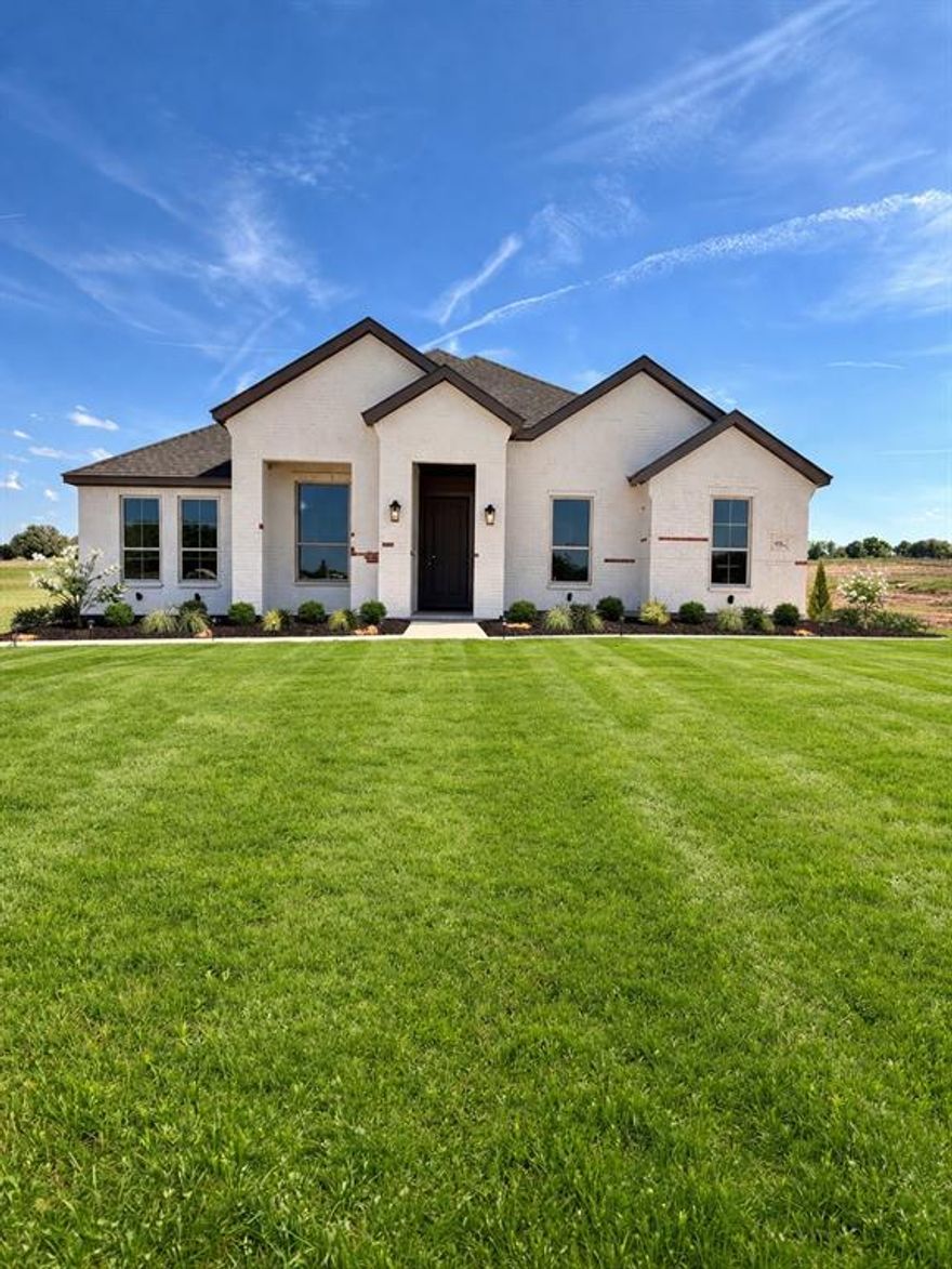Experience refined country living on just over an acre, where space, style, and freedom come together beautifully. This thoughtfully designed 3-bedroom home with a dedicated study, 2 full baths, and just under 2300 sq ft. offers a highly functional open-concept floor plan perfect for both everyday living and entertaining. The heart of the home is a stunning, upgraded kitchen featuring an abundance of premium finishes, seamlessly flowing into the spacious family room. A striking painted brick fireplace extending to the ceiling, complemented by a rich stained mantle, creates a warm yet sophisticated focal point. Custom built-ins with floating wood shelves add both charm and practicality. Designed with convenience in mind, the home includes a mud bench with a built-in desk and charging station ideal for modern living. Architectural details continue outdoors with cedar posts framing the inviting front porch, along with matching cedar shutters accenting the third bedroom and garage windows for timeless curb appeal. Enjoy the benefits of a NO HOA community and a low tax rate, offering greater flexibility and long-term savings. This property perfectly blends luxury finishes with the peace and privacy of country living, an exceptional place to call home.