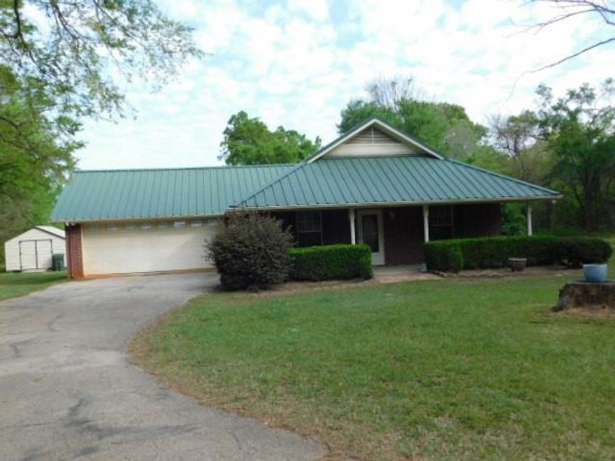 Lovely home, beautiful setting with large trees surround the property. Renovated just before listing for sale. New paint, carpet, vinyl plank floors, redone master bathroom, with new shower and fixtures, also redone 2nd bath fixtures as well, new ceiling fans. Kitchen is spic and span. It all looks brand new. This 2 bedroom home also has a small office that can possibility be a third bedroom. You really need to come take a look to appreciate the condition, setting, and beauty of this home built in 2002 and well maintained throughout the years. New ceiling fans on the back and front porch enables you to sit, relax and enjoy the serene atmosphere. Property has a back property line fence. There are two gates that will be taken down prior to sale and do not go with the property. There is a 12 x 20 storage building for all your equipment, hobbies, tools and toys. This property was built and enjoyed by the owners. Come take a look, you will love it too.