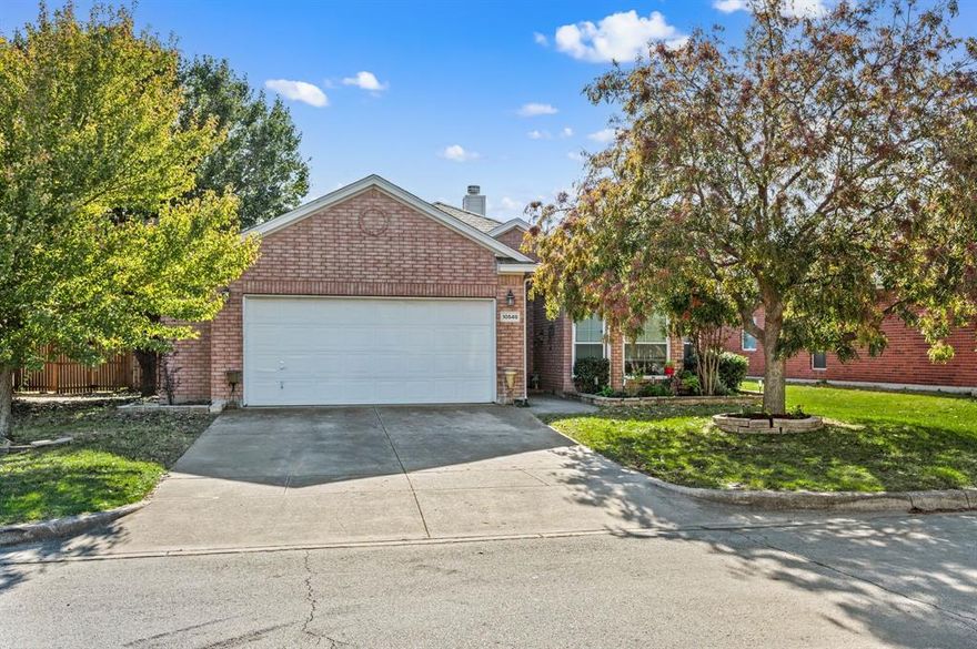 Seller is offering a one year temporary buy down!! Welcome home to this beautifully designed single story home featuring an inviting open floor plan perfect for entertaining and everyday living.The spacious living area boasts with vaulted ceilings and a cozy wood burning fireplace, creating a warm and welcoming atmosphere. The kitchen flows seamlessly into the living and dining area making it a chef's delight. The window above the sink provides beautiful natural light, making it a bright and cheerful space for cooking and gathering. Kitchen offers granite countertops, subway tile backsplash, stainless steel appliances, and ample cabinet space. The split bedroom floor plan offers privacy, with a spacious primary suite separate from the secondary bedrooms. Primary bath features a large garden tub, separate shower, and dual sink vanity. The front bedroom includes a charming bay window, adding style and character. Step outside to the covered back patio, perfect for relaxing evenings or weekend barbecues. Enjoy peace of mind with a new HVAC unit replaced in April 2025.Conveniently located close to shopping, dining and top rated Northwest ISD schools, this home combines comfort, convenience, and style in one perfect package. Don't miss your chance to own this beautiful home in time for the holidays!!