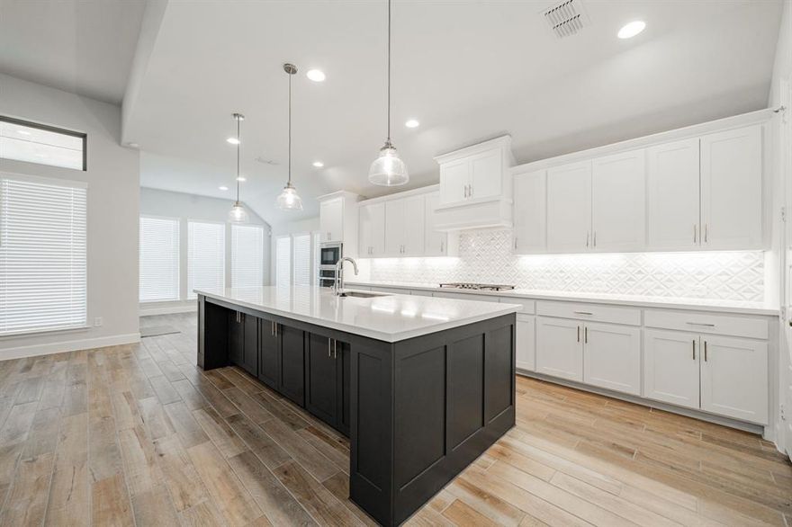 BACK ON MARKET due to buyer’s contingency falling through. Welcome to 10480 Gray Hills Drive, a beautifully designed four-bedroom home in Fort Worth that blends spacious elegance with everyday functionality on a 70' lot. A grand extended entry with soaring 12-foot ceilings sets the tone and leads seamlessly into the open-concept family room, kitchen, and dining area, perfect for both entertaining and daily living. The family room impresses with its 12-foot ceiling, cozy wood mantel fireplace, and a stunning wall of windows that fills the space with natural light. The kitchen is a true centerpiece, offering abundant counter space, a large island with built-in seating, a 5-burner gas cooktop, and a walk-in pantry, ideal for hosting or casual meals at home. Just off the family room, a versatile game room with French doors provides flexible space for work, play, or relaxation. The private primary suite is a serene retreat, featuring a 13-foot ceiling and wall of windows. The spa-like primary bath includes dual vanities, a freestanding soaking tub, a separate glass-enclosed shower, and two walk-in closets. A Hollywood bath adds convenience and style to this thoughtfully planned home. Enjoy outdoor living on the extended covered backyard patio, perfect for relaxing or entertaining. Additional highlights include a functional mudroom and a three-car garage offering ample storage. This home combines thoughtful design, generous space, and modern comfort in a desirable Fort Worth location—ready to welcome you home.
