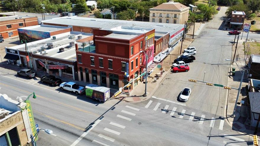 OWN A PIECE OF MINERAL WELLS HISTORY. The 3600 sqft brick building built in 1906 sits on a corner lot with additional access on both N Oak Ave and Second St. Originally located next to the historic Livery Stable, and is currently located between the Crazy Water Hotel (a popular shopping and dining destination), and the infamous Baker Hotel (under renovation). This beautiful piece of history is surrounded by thriving businesses. Including boutiques, restaurants, and professional offices. The first floor store front is open door ready. While the second floor will be semi completed prior to closing. The third floor balcony is accessible from the second floor loft, and provides stunning views of the surrounding mountains and historic buildings.  Seller may build to suit upon additional consideration. This is a fantastic opportunity to own a historic corner building within the beating heart of Mineral Wells and Crazy Water central.
