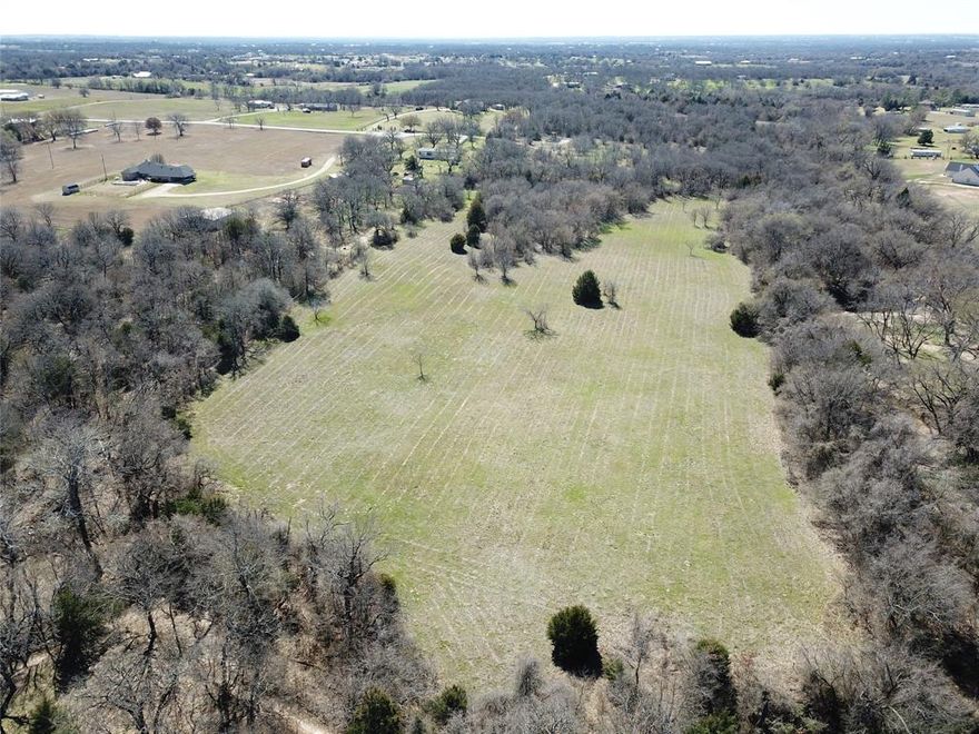 Are you looking for a beautiful place to build your dream home or barndominium?  This 18-acre property is the perfect place to call home!   
NO RESTRICTIONS, at the end of a cul-de-sac, an abundance of mature trees, perfect build sites, and Walnut Creek running along the west boundary line of the property.  This property has all the amenities of country living but conveniently located 45 minutes from DFW Airport, 30 minutes from Alliance Town Center, and 10 minutes from downtown Decatur.  
Call today to schedule your private showing.