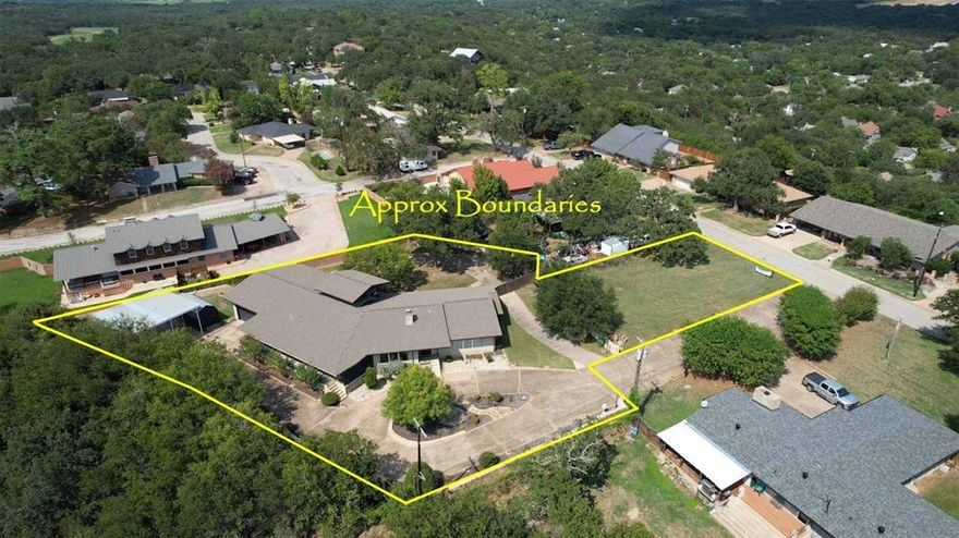 MOTIVATED SELLER READY FOR OFFERS on this Exceptional & Versatile Home in the Heart of Mineral Wells! Step inside to an inviting living area centered around a one-of-a-kind fireplace, complemented by a wall of windows that flood the space with natural light. The chef’s kitchen is a true highlight, featuring a Subzero refrigerator, two gas ovens, a central island with an electric cooktop, & seating. Sliding doors open to an expansive covered patio—perfect for entertaining. Designed with flexibility in mind, the floor plan is ideal for multi-generational living or hosting guests. All four bedrooms are located on the main level, including a private suite with its own sitting area & exterior entrance, as well as another bedroom with an ensuite bath. Upstairs, a charming turret-style room offers a versatile space for a home office, game room, or even a private stargazing retreat, with breathtaking views framed by walls of windows. Other features: well-appointed utility room with garage access, walk-in pantry, space for a freezer, washer & dryer hookups, & a half bath. Just five minutes from the historic Baker Hotel, this remarkable home offers a unique blend of charm, functionality, & accessibility. Recently redesigned with plans for an Assisted Living Center, thoughtful features such as wider doorways, bathroom handrails, multiple access ramps, fire alarm & sprinkler system, and a secure safe room are in place —enhancing both comfort & safety. Outside, the property is equally impressive. A long driveway welcomes you with a lush green space at the entrance, leading to an RV carport & drive-through garage that connects to a wraparound driveway. The fully enclosed backyard provides multiple seating areas & a separate fenced section, ideal for storage, pets, or additional customization. Perched on an elevated street, this home offers picturesque views of a serene, wooded greenspace, creating the perfect balance of privacy & convenience in the vibrant & growing MW community!