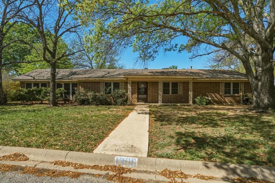 Elegant 4-bedroom, 3-bath brick residence with office space located in one of Coleman’s most prestigious neighborhoods on the Hill. Nestled beneath towering live oak trees on an almost half-acre lot, this nearly 2,000 sq ft home offers exceptional space, privacy, and thoughtful design. Two fenced back yards create versatile outdoor living options, complemented by covered front and back porches ideal for relaxing or entertaining.
The open-concept interior flows seamlessly from the living area to dining and into a beautifully updated kitchen. A brick wood-burning fireplace with mantle anchors the living space, while the chef’s kitchen features marble countertops, custom wood cabinetry, decorative lighting, double ovens, gas cooktop, dishwasher, built-in microwave, and bar-top seating.
The well-designed floor plan includes two guest bedrooms with a full bath, a private secondary primary suite with double closets and full bath, and a sequestered primary retreat offering double closets, full bath, and an adjoining bonus room perfect for an office or flex space. Double doors from the office or flex space open to a private fenced courtyard, creating a serene work-from-home setting.
Recent improvements include a Level 4 roof and rain gutters installed in 2024, fresh interior paint on walls and ceilings, luxury vinyl plank flooring in the living room and kitchen, new kitchen cabinetry, countertops, and lighting, new carpet in guest bedrooms, and select updates to ceiling fans, plumbing fixtures, and toilets. Alley access leads to a covered back porch, attached 2-car carport, and driveway. A rare opportunity to own a beautifully updated home offering luxury and functionality in one of the loveliest neighborhoods in Coleman.
