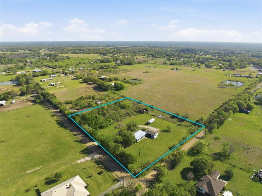 Situated on 2.52 acres in the rural Texas countryside, this 1,344 sq ft doublewide offers 3 bedrooms, 2 bathrooms, room to spread out, and the freedom of country living. Step into a spacious living room with plenty of space to gather, relax, or unwind. The open kitchen flows easily into the connected dining area, creating a functional layout for everyday living and casual entertaining. The spacious ensuite primary bedroom features a walk-in closet and ensuite bath, while the secondary bedrooms offer flexibility for guests, hobbies, or workspace. Outside, enjoy the wide-open setting, a new back porch metal roof installed in 2025, and 2 car covered parking for added convenience. Located in Scurry ISD, this property offers a country setting with convenient access to Dallas. Being sold as is, it presents an opportunity to make it your own! Claim Your Piece of Texas!