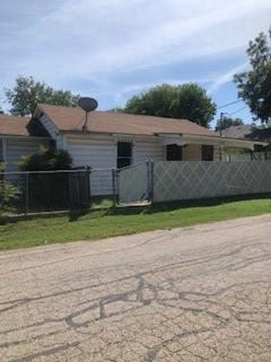 Investment opportunity for investors of the DIY homeowner!!!!  This home has a covered front porch.  Welcome inside to a large living area with fire place, oversized eating area and kitchen.  The washer and dryer are in a separate laundry room!  The main bedroom is on the left of the home and is full of windows.  Full bath with shower-tub combination.  The guest bedroom is quaint and on the right side of the home.  A detached garage and chain link fenced yard completes the package.