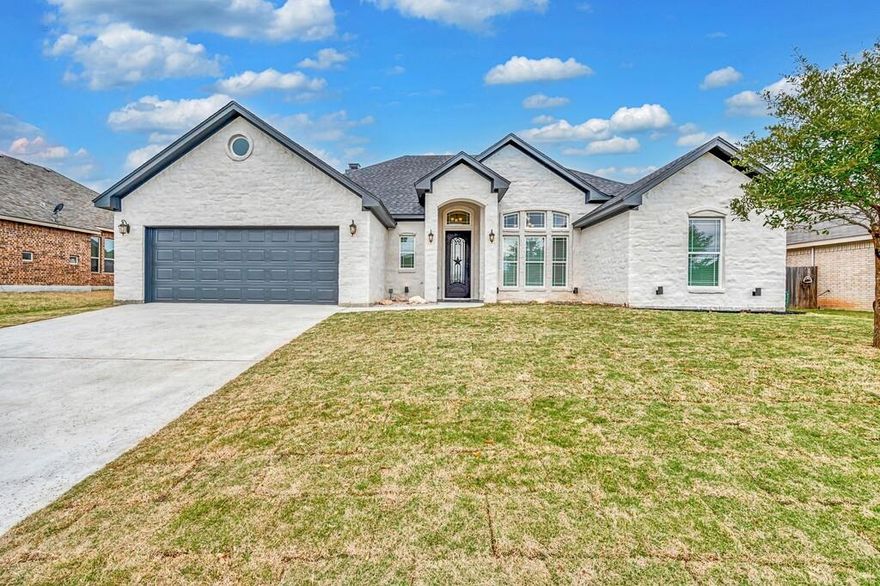 Welcome Home! This one has it all. The bedrooms are a nice size; all with ceiling fans and window coverings. This home features an open floor plan with a formal dining area for when you want to entertain, or to enjoy those special occassions. A separate laundry room features storage space. The main bedroom is isolated with a big adjacent bathroom, complete with double vanities, a great glass-enclosed shower, and a whirlpool tub! Stained concrete flooring all over the house. This flooring makes cleaning a breeze, and looks fantastic. Great kitchen with a big pantry. Enjoy your afternoons cooking in the outdoor kitchen under the covered patio...a perfect place to gather with family and friends. The yard is complete with grass and sprinkler system all over. Taxes are on the land only. (Buyer and Buyers agent to verify the information.)