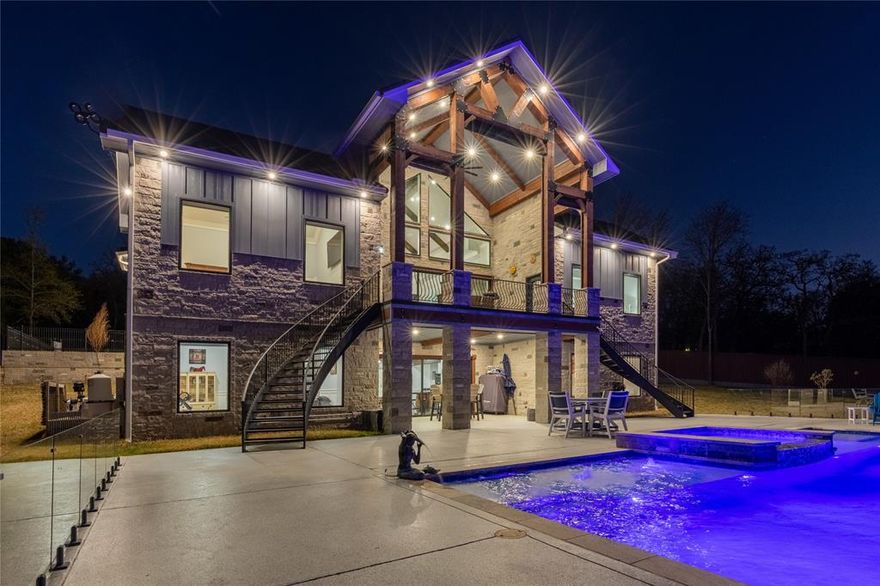 Resort style lake living at it's finest. Custom 5 bedrooms, 5 baths, 3 Living areas, 2 Dining Areas, Media Room, Huge Gameroom area with 2 living areas, Pool Table and shuffleboard. Oversized restuarant style and size bar is great for entertaining. 2 Master suites, both with ensuite baths and privacy balcony off each bedroom with winding staircase leading to pool area. Hot Tub, Heated Infinity Pool with fountains. Covered dock with electric boat cover. 300 ft of open waterfront property on 4 acres with a 2000 sq ft Workshop with electricity and full RV hookups. This house has beautiful wookwork and stonework throughout.. The beautiful bar has illumination lights in the counters and around the TV and woodwork as well as the entertaining Media room. Gated Community. Cathedral ceiling throughout. Kitchen is a chefs delight with custom gas cooktop, double convection oven and drop in microwave. Both master suite has beautiful views of the lake and beautiful sunsets. Media room with surround sound. The workshop has 18ft roll up doors and a bathroom. The inviting living, dining area is great for entertaining as they are all open. The kitchen has an island with bar that seats many family members and guests. Expansive parking and parking for an RV with full hook ups on the driveway area. Wooded lot for privacy. The dock has concrete walkway instead of wood with storage area and walking area across the property at the lake. Beautiful palm trees and fountains around the pool and yard. This home has so many features, you have to see it for yourself! It's filled with high end touches throughout the house.