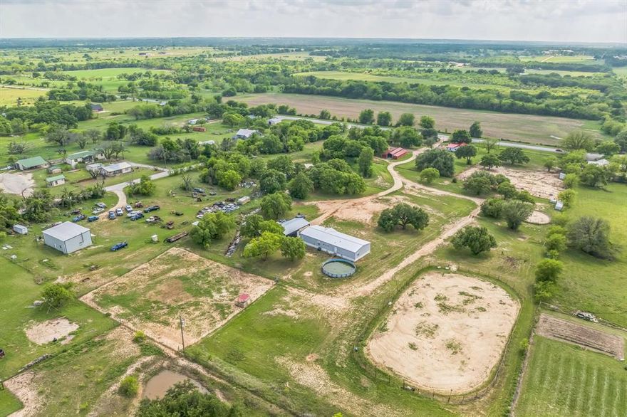 Discover the perfect blend of rustic charm, modern upgrades, and ranch-ready amenities in this rare, multi-functional, multi-generational property—tailor-made for horse enthusiasts, livestock owners, or anyone dreaming of the ultimate Texas homestead. Located in the heart of Stephenville, this one-of-a-kind property offers two separate residences and an impressive list of features and improvements since 2021, all set on a fully functional ranch designed to make both living and working on the land easy and enjoyable.

Two Homes, Endless Possibilities, Primary Residence (Front of Property), classic ranch-style home bursting with authentic charm with original hardwood floors and freshly painted siding, updated electrical system (2023), and lifetime metal roof (2023) for peace of mind and longevity. Second Residence (Back of Property) is a brand new 2024 manufactured Orleans Model home with spacious layout containing 2,400 sq. ft. 4 bedrooms, 2 full baths, and two living areas which is ideal for extended family, guests, or income-producing rental.

Equine & Livestock Amenities include: (7) 30 x 30 horse paddocks – roomy and ready,  (2) paddocks with shelters and corral panels, 60 ft. round pen & 100 x 200 outdoor arena – perfect for training or recreation, fully fenced cattle area – ready for your herd, 36 x 60 horse barn featuring:
11 concrete-floored stalls with mats, wash rack & tack room – functionality meets convenience, 2 large chicken coops – fresh eggs & farm charm daily., and 25 x 45 fully concreted shop. The second home is equipped with a two bay carport and 30 ft. above-ground swimming pool. 

The Total Package in Cowboy Country! From its turnkey equestrian setup to comfortable multi-residence living, this Stephenville stunner is a true gem that rarely comes to market. Whether you're building a legacy, running a working ranch, or just craving wide-open skies with family by your side—this property is ready to welcome you home.