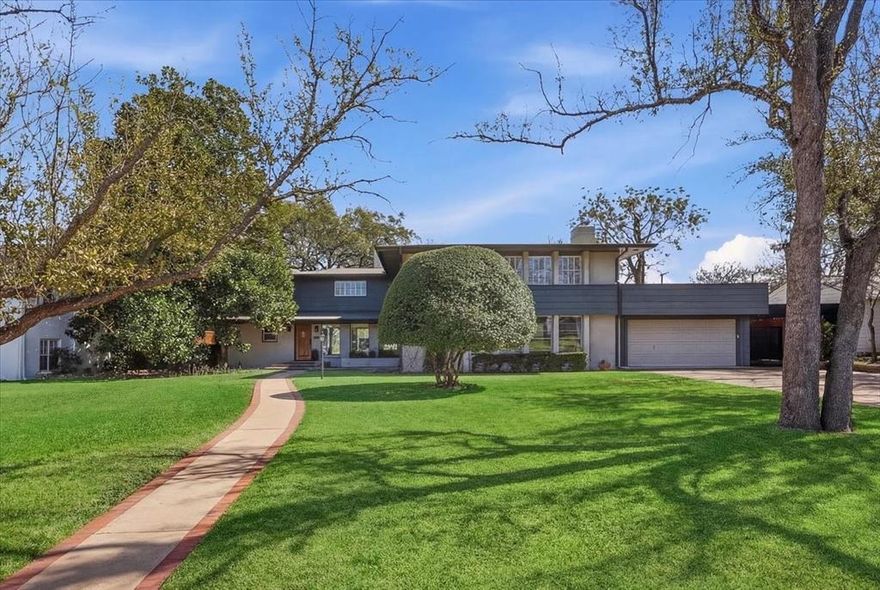 Built on a park-like half-acre lot and located  in a distinguished neighborhood known for charm and distinctive homes, this rambling, much-loved home enjoys a delightful location in every way: a very safe, wallkable neighborhood; dozens of restaurants; great shopping; grocery stores; and a  public library - all within easy walking distance. Nearby Ridglea Country Club is an important jewel in the Ridglea universe, offering two extraordinary golf courses, Olympic size pool, tennis, work-out facility, and countless opportunities for indoor and outdoor entertainment. It's the kind of neighborhood people never want to leave. The architecture is traditional mid-century with  4025 square feet, 5 bedrooms, 4 bathrooms, 2 living areas, kitchen, and 2 dining areas. Built in 1951 , it reflects the post war American Dream of a nice, large home with a big yard for kids to play, a neighborhood park and a safe, pretty environmnent (Like the Brady Bunch house!). The current owners raised their family in this house for the last 24 years. Both living areas are spacious and have handsome flagstone fireplaces anchoring the spaces. There's abundant natural light and beautiful views front and back. Original wood flooring has the warm patina of time adding character and appeal. The kitchen has granite counter tops, a built-in banquette in the breakfast area, and parquet flooring. There is a charming bedroom on the ground floor with its own sitting area and bath. Four additional bedrooms and 3 baths are on the second floor. The primary suite is huge, and offers many remodeling possibilities. The owners added a grand pergola outside creating an ideal setting for entertaining, drinks, outside dining, and peaceful reflection. There is a 2-car garage. Solar panels increase the home's energy efficiency. The lot is approx. 109' x 235'. Big lots in desireable areas are scarce, and this is a tremendous value.