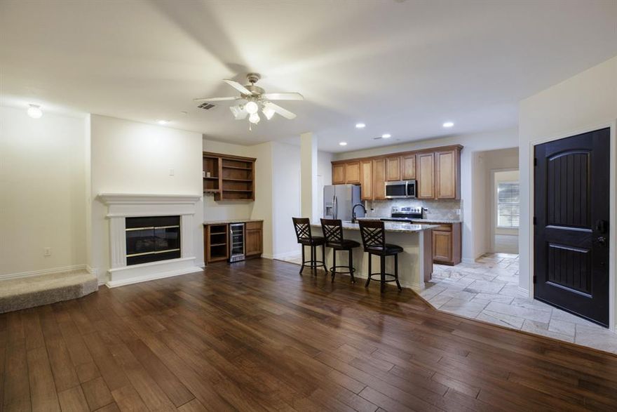 Experience the ultimate lock-and-leave lifestyle in this beautifully updated townhome nestled within the sought-after Hemmingway at Craig Ranch community. Perfectly set along the edge of the award-winning TPC Craig Ranch golf course, this home offers effortless living, modern comfort, and resort-style amenities just outside your front door. Inside find pride of ownership throughout, from the fresh interior paint and new carpet to refined finishes including 1 inch granite countertops, travertine flooring, and an extended breakfast bar. The open-concept living, dining, and kitchen area is designed for connection, featuring engineered hardwood flooring, a cozy gas fireplace, and a wine bar with built-ins- ideal for unwinding with a glass after a round on the greens. The spacious primary suite is located on the main level, offering a vaulted ceiling, dual vanities, travertine tile, a soaking tub, a walk-in shower, and a generous closet. The laundry room and a convenient half bath are also on the first floor, keeping daily living comfortable and functional. Upstairs, you’ll find two additional bedrooms, a full bath, a versatile game room perfect for an office or additional living space. A large linen closet provides extra storage, and an upgraded HVAC system ensures comfort year-round. The attached two-car garage features epoxy flooring and space for golf club storage. Outside, a low-maintenance friendly community makes it easy to relax or lock and leave without worry. Enjoy access to community amenities including a resort-style pool, fitness center, clubhouse, playground, and dog park—just steps away. Perfectly positioned near Highway 121 and zoned for acclaimed Frisco ISD schools, this home offers convenient access to shopping, dining, and entertainment while capturing the essence of McKinney living. Whether you’re teeing off at TPC Craig Ranch’s newly renovated course or simply enjoying the serenity of your neighborhood, every day here feels like a getaway.
