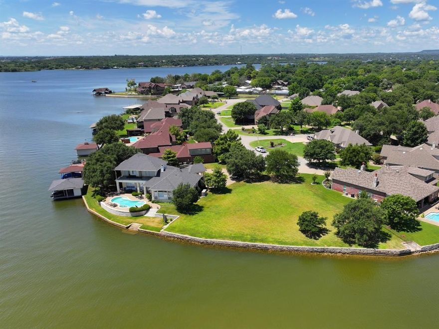 MAINBODY WATERFRONT LOT in the highly sought after prestigious community of Timber Cove with HUGE VIEWS. Nearly a half acre of prime lakefront property on one of the widest sections of Lake Granbury with approximately 185 feet of waterfrontage! Surrounded by gorgeous homes in this gated community, this is the place to build your dream home. There are not many walk-out waterfront lots like this left available. Located on the Fort Worth side of town, this area is a quick commute to the Metro-plex and just minutes for major grocery stores, shopping, dining, and entertainment. Lake Granbury is a 33-mile long waterfront paradise with excellent lakeside restaurants and marinas. Granbury's Historic Downtown Square offers a plethora of things to do and many fun festivals throughout the year. Whether you are looking for a full-time residence or a weekender, this one is the place to call home! Enjoy the Texas sunrises as you've never seen them and live your best lake life!