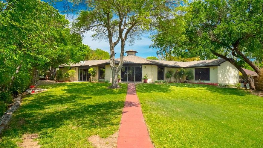 A Private Retreat with Endless Potential in desirable Aledo ISD – Acres of Peace, Privacy & Possibility! Welcome to your own private sanctuary nestled on 2.248 acres of serene, nature-filled land in a prime location. This one-of-a-kind property offers a rare blend of space, versatility, and potential, featuring a main residence, a separate guest house, & a climate-controlled storage building perfect for a home office, workshop, or creative studio. Step inside the main house to find a spacious, open-concept living area complete with a wet bar—ideal for entertaining. The kitchen offers an abundance of cabinet and counter space, while the adjacent dining nook enjoys beautiful natural light. The primary suite is your personal retreat with an ensuite bath featuring double vanities, a jetted tub, separate shower, & dual walk-in closets. A second bedroom with its own full bath sits near a dedicated gym room & convenient half bath. Each room enjoys access to private outdoor patios or decks—perfect for morning coffee or evening stargazing. The separate guest house includes one bedroom and a cozy living area—perfect for hosting guests. Outdoor living is where this property truly shines. Multiple decks and sitting areas, a tiki hut, and a sparkling pool offer endless spots to unwind and soak in the natural beauty. Sprinkler system and pool water source from private water well. Keep an eye out for local wildlife—deer, foxes, and songbirds are frequent visitors. With a 1-car garage, 2 covered carport spaces, & ample room for expansion, this property offers incredible flexibility. While the home itself is ready for your personal touch and updating, the bones are solid & the opportunities are limitless. Whether you're dreaming of a private homestead, a multi-generational living setup, or a vacation-style retreat, this property is your blank canvas. Approximately three minutes from restaurants, medical offices, hospital & highway I-20.