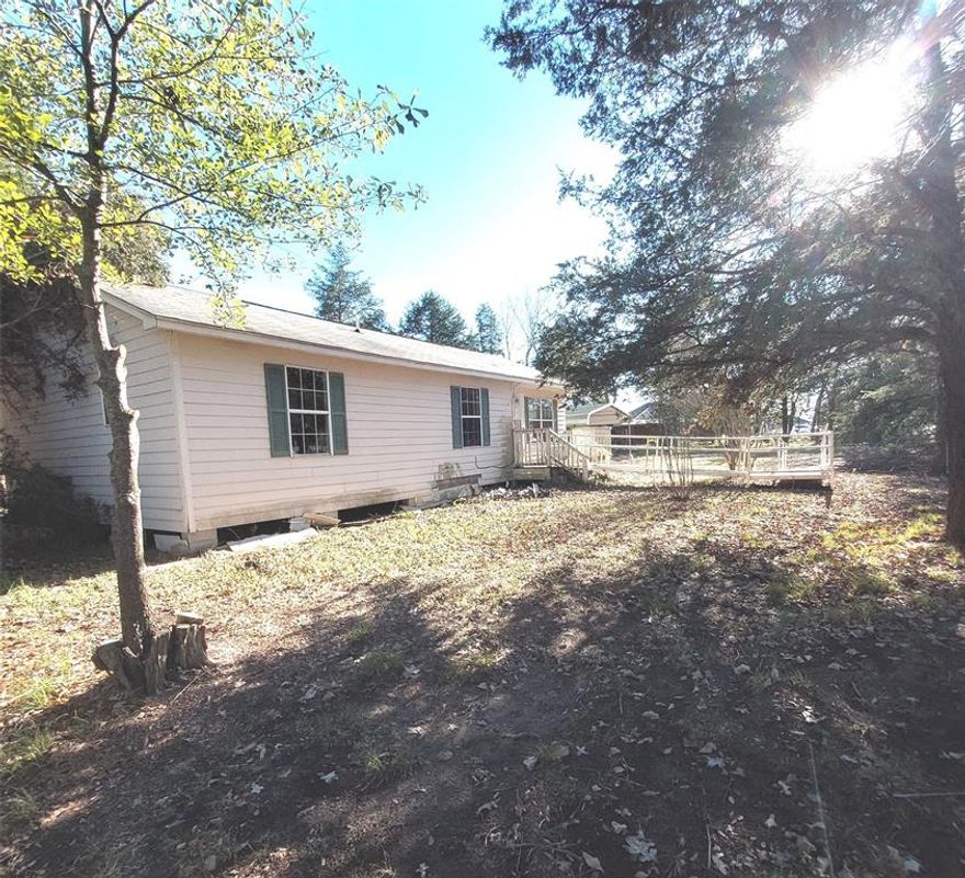 Great country setting only minutes from town and the Bonham Lake. This home sits on a 1.61 acre wooded lot. There is a detached carport and wheelchair ramp. This home offers an open living room and dining area and a galley style kitchen. Primary bedroom has an ensuite bathroom. Lots of opportunity to make this home yours. There is also a storage building in the back yard. Conveniently located only minutes from the lake or shopping and dining in Bonham Tx. Easy commute to Sherman or DFW area. Come take a look today. Sold AS-IS.