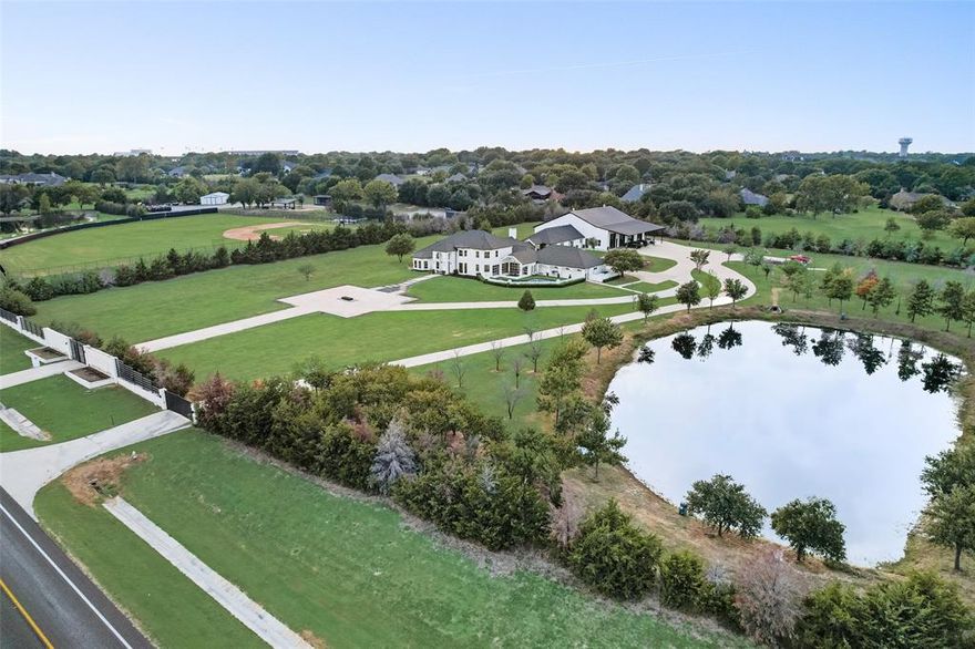 *Multiple Offers Received; best & final by Wed 8-21 at 1:00* Incredible opportunity to own this modern luxury estate situated on 7.5 acres in the HEART OF HEATH. This extraordinary property with 2 gated entrances & serene stocked pond offers a 6,171 SF main home, a 1,530 SF guest house, & a 6,400 SF recreation building.  Enter through the stately foyer which seamlessly connects multiple living areas with expansive windows & patio garage door walls. The true CHEFS KITCHEN with top-of-the-line appliances include dual gas stoves, a Hibachi Grill, a full service prep pantry & a Buffet sitting area. Primary suite is customized in design & finish out with floating cabinets & custom closet with beverage bar & fridge.  Spectacular outdoor living with fireplace & grilling kitchen along with a private heated waterfall pool & spa.  The custom guest house has 2 Br, 1 Bath, FR, DR, full service kitchen & laundry room.  The recreation building has an HVAC system, custom bath & full service kitchen.