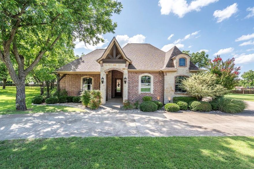The definition of Open Concept and Outdoor Living! Come see this one of kind property in the gated community of Pecan Plantation, Granbury with 4 bedroom, 3.5 bath, 2 dining, 2 living, plus a dedicated study area. This home could easily be used for multi-generational living, as the primary and guest bedrooms are separate from the secluded TV room flanked by two bedrooms and a bath; a separate wing with the close of a door! The heartbeat of the home features a designer remodeled kitchen with Kitchenaid Cafe appliances, Blue Dunes leathered granite, white oak columns, a Blanco sink and Brizo plumbing accessories. Just steps away, the Outdoor Kitchen will keep the Grill Master busy year round with a Blaze 5-burner grill, Cal-Fire griddle and a Danby refrigerator for keeping beverages cold. The L-shaped Giallo Cream outdoor granite island seats up to 12, so everyone is always welcome! Not to be out done, the Pool's Outdoor Living is the perfect spot after a dip in the pool to catch the game under the big a$$ fan or warm up around the Austin Cream Stone fireplace. Need to the throw the ball or start a garden, with the affordable Orchard Irrigation and FENCED pie-shaped backyard, there is MORE than enough room to stretch out, or just roam the yard. Inside, the wood floors are highly durable and compliment the new carpet. The 2025 Class 4 Roof is impact resistant, eligible for insurance premium discounts, an investment. Last but not least, FIVE garage spaces and an additional walk-in attic space. Ready to venture into the neighborhood? The Country Club feel with it's vast amenities won't disappoint! With a proposed third golf course, pickleball and tennis courts, two community pools and an Activity Center, it's easy to stay active. There's also, a Marina, an Equestrian Center, RV park, camp ground, two airstrips, a grocery store, gas station, drug store, pizzeria, Ace Hardware, Country Club activities and multiple restaurants. There truly is something for everyone!