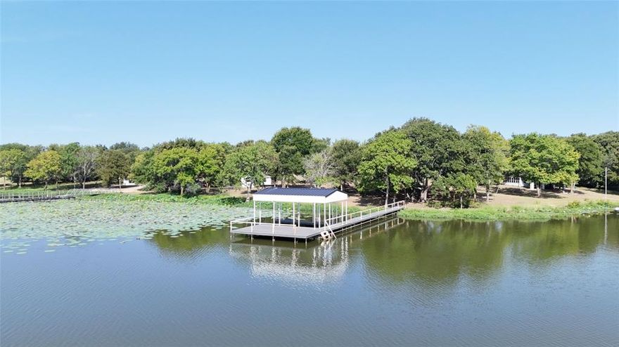 This exceptional waterfront lot is primed and ready for you to build the ultimate dream retreat. The property features a charming dry cabin with a cozy, small fenced yard, a convenient tuff shed, and a welcoming porch for easy access. But that’s just the beginning! Included with the cabin is your very own private covered boat dock, boasting one boat slip complete with an electric lift, ensuring your watercraft is always ready for your next adventure. The floating boat dock is ideal for fishing boats and kayaks, giving you endless options for fun on the water. Recently updated with durable metal siding and low-maintenance TREX decking, this dock combines longevity with style. Additionally, you can enjoy the expansive 10'x28' uncovered deck—perfect for enjoying stunning sunsets or casting in a line. Spanning 0.82 acres of deeded land, plus an additional 1.2 acres of leaseback SRA land, this property offers plenty of space for your lakeside vision. You could almost double the amount of building area with the adjacent lot, lot 13, which is also listed for sale (MLS 21017279)! The interior of the dry cabin showcases updated shaker cabinets and beautiful granite countertops, along with an electric range and refrigerator that enhance your lake experience. Ceiling fans and solar screens add extra comfort for those warm summer days. As an added bonus, the adjacent Waters Edge common area features a charming gazebo, scenic park, floating marina, restrooms, and ample guest parking, making it easy to entertain friends and family. Enjoy resident access to these well-maintained amenities, all supported by a remarkably affordable annual HOA fee of only $300. This is more than just a property; it’s an opportunity to create lasting memories with family and friends in a blissful lakeside setting. Make your lake escape a reality today! PLEASE NOTE: Cabin is not able to be lived in. All information deemed reliable but should be verified by buyer and buyers agent.