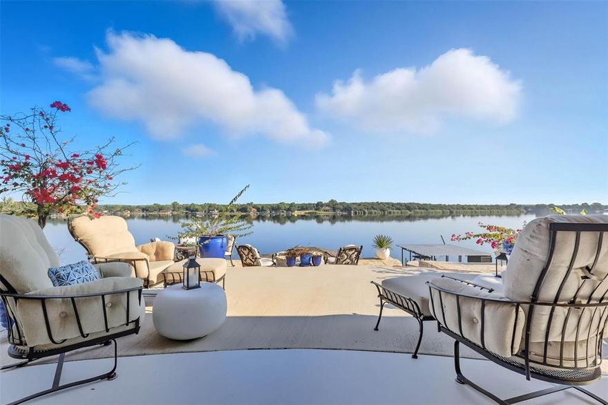 Welcome to lakefront luxury redefined. This stately and impressive Mediterranean-style Lake House is an architectural masterpiece, perfectly positioned on the deep, pristine waters of Lake Granbury’s main body. A true gem for those seeking serenity, sophistication, and unmatched views, this 3-BE, 3.5-BA home delivers a lifestyle of lakeside elegance & comfort. From the moment you arrive, you'll be captivated by the home’s commanding presence & peaceful setting. Step inside to discover soaring ceilings, expansive living spaces & enormous windows that frame breathtaking, panoramic views of the tranquil lake. The luxurious primary suite is a private sanctuary, where you’ll wake up each morning to awe-inspiring lake vistas. The spa-inspired en-suite bath features a soaking tub, walk-in shower & dual vanities—designed for ultimate relaxation & rejuvenation The open-concept living area flows into the gourmet kitchen is a chef’s dream, boasting state-of-the-art appliances, abundant counter space & custom cabinetry upgraded w convenient pull-out drawers, ensuring practicality. A 2nd downstairs BE can double as an office adding  flexibility, while a grand staircase leads to a spacious upstairs game room—perfect for home theater space, currently being used as textile business. Massive 3rd BE upstairs w adjoining BA feat grand balcony w lakeview - could be 2nd Living or guest suite. Outside, the lakeside oasis continues. The newly renovated-2025 Boat Dock includes a boat lift, dual jet ski ramps & covered & uncovered lounge areas—perfect for sunbathing, outdoor dining. For additional comfort and flexibility, the estate features a detached 1-BE, 1-BA Casita—ideal for multi-generational living, guest accommodations or private home office. This rare offering presents a truly exceptional opportunity to experience Lake Granbury living at its finest—a lifestyle of beauty, peace & timeless luxury.