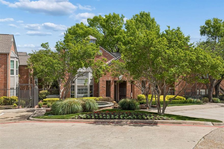 Tucked inside the gated Williamsburg Condo Community, this Preston Hollow condo offers comfort, light-filled spaces, and easy living. Bright walls, soaring ceilings and expansive windows bring in abundant natural light throughout. The inviting living area features a wood-burning fireplace, creating a warm focal point for relaxing evenings. Step outside to a spacious, covered balcony—an ideal retreat for morning coffee or winding down at the end of the day. The kitchen is well-equipped for everyday cooking, with a nearby breakfast nook perfect for casual dining. The generously sized primary suite showcases charming bay windows, a large walk-in closet, and a well-appointed bath with dual sinks and an oversized shower. Full-size washer and dryer connections add everyday convenience. Residents enjoy access to community amenities including pools, a spa, fitness center, and clubhouse.